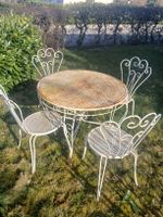 Table de jardin  et 4 chaises anciennes en métal forgé,