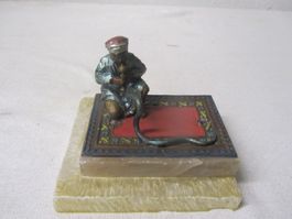 Orientale sitzend auf Teppich als Briebeschwerer