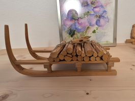 Dekorativer Holzschlitten mit Holzstabel selbst geschnitzt