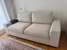 Sofa bed with wide armrests, beige