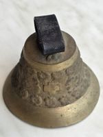 Vintage brass bell with Swiss cross design.