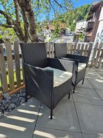 Rattansessel mit Kissen