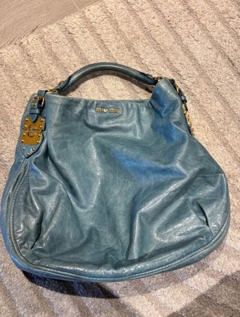 Sac hobo Miu Miu en cuir bleu, détails dorés, état bon