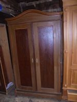 Antiker Kleiderschrank aus dunklem Holz mit geschwungener...