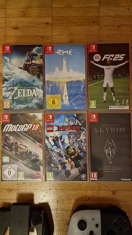 Konsolen: Nintendo Switch OLED + accessoires + 6 jeux + housse – Gebraucht aus Cressier NE von Couleur3 1