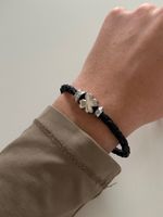 Bracelet Fossil noir avec trèfle