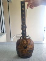 Treichel mit Lederriemen und Sonnenmotiv