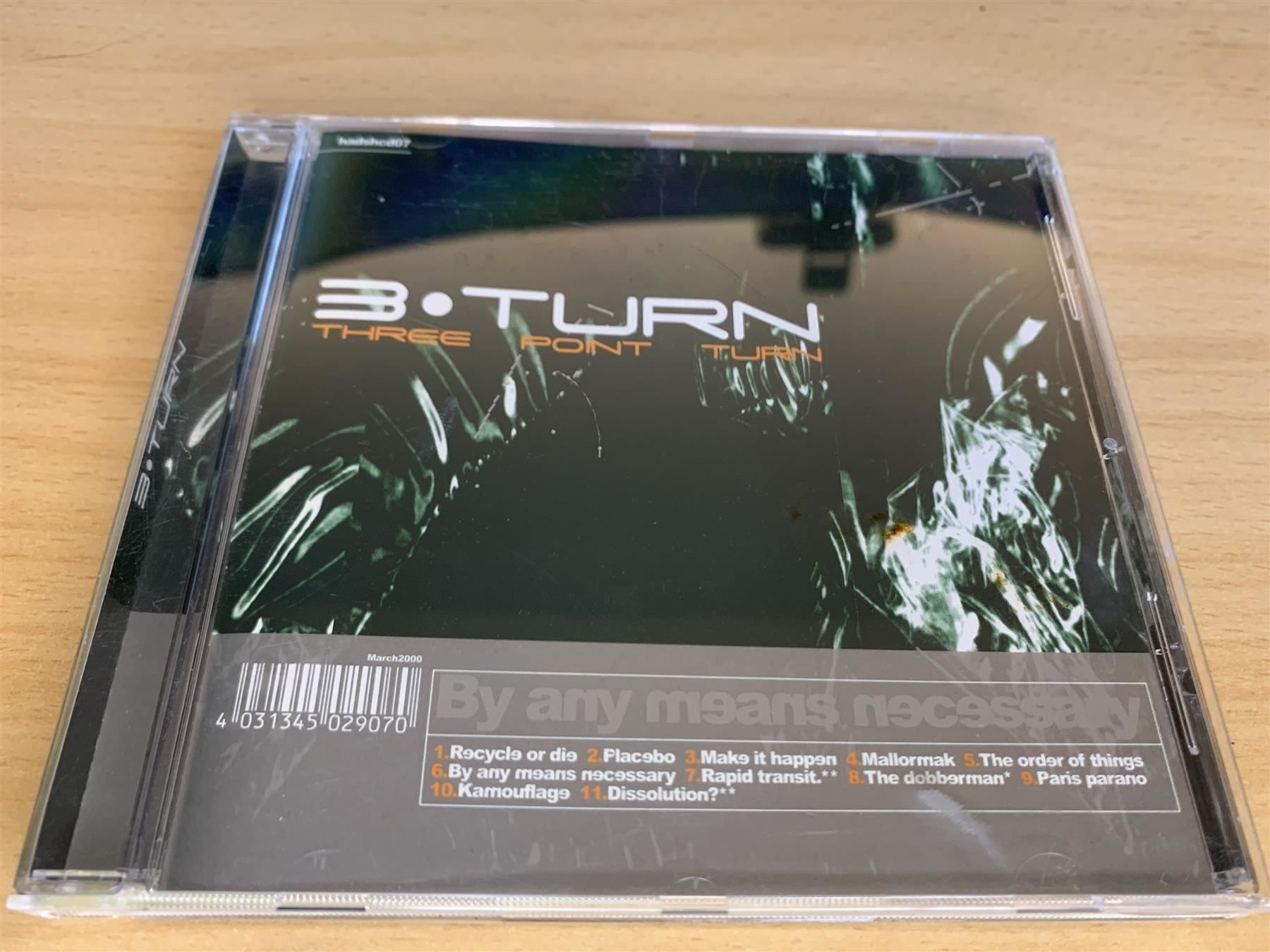 CD: Three Point Turn -  By Any Means Necessa – Usato da Rikon im Tösstal venduto da Alpenmutz