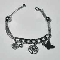 Bracciale con ciondoli albero e farfalla