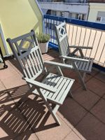 Two solid wood outdoor reclining chairs