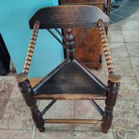 Antique corner chair dark wood spindle back design