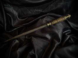 Antique wooden wand with metal accents