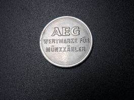 Token: AEG Wertmarke für Münzzähler