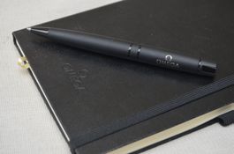 Omega Kugelschreiber + Notizbuch / Stylo à Bille + cahier