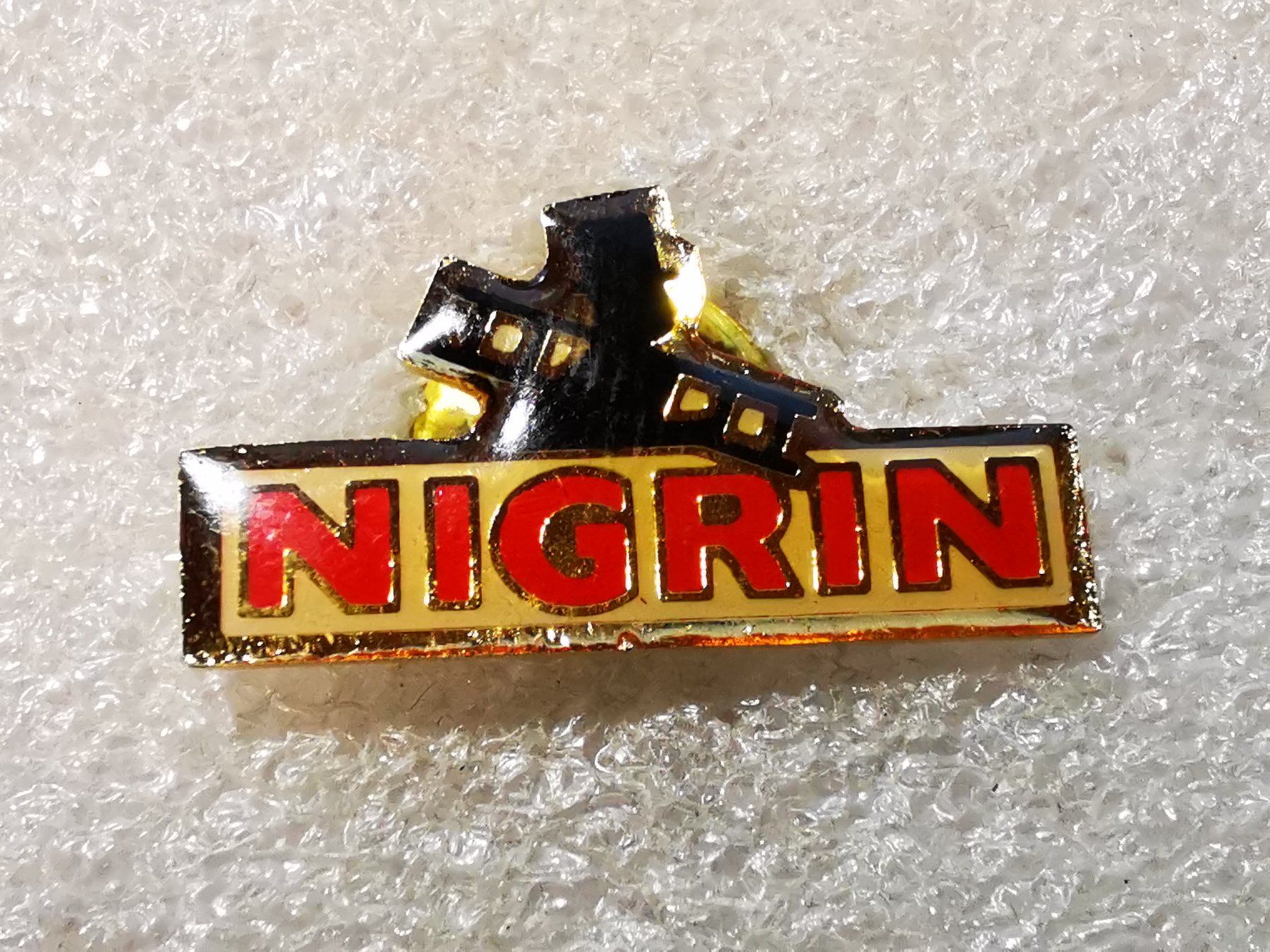 Placchette & Badge: Ansteckpin 48: Nigrin – Usato da Oppligen venduto da Pin-Fall-Shop