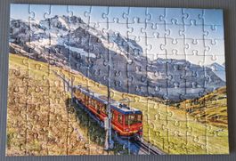 Ravensburger Puzzle(CZ) 99 Teile. Jungfraubahn