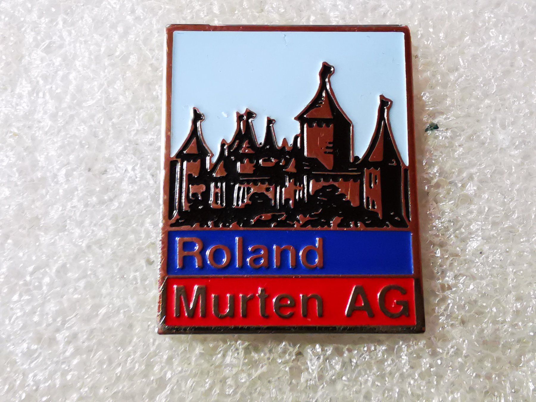 Plaketten & Abzeichen: Ansteckpin 96: Roland AG Murten – Gebraucht aus Oppligen von Pin-Fall-Shop