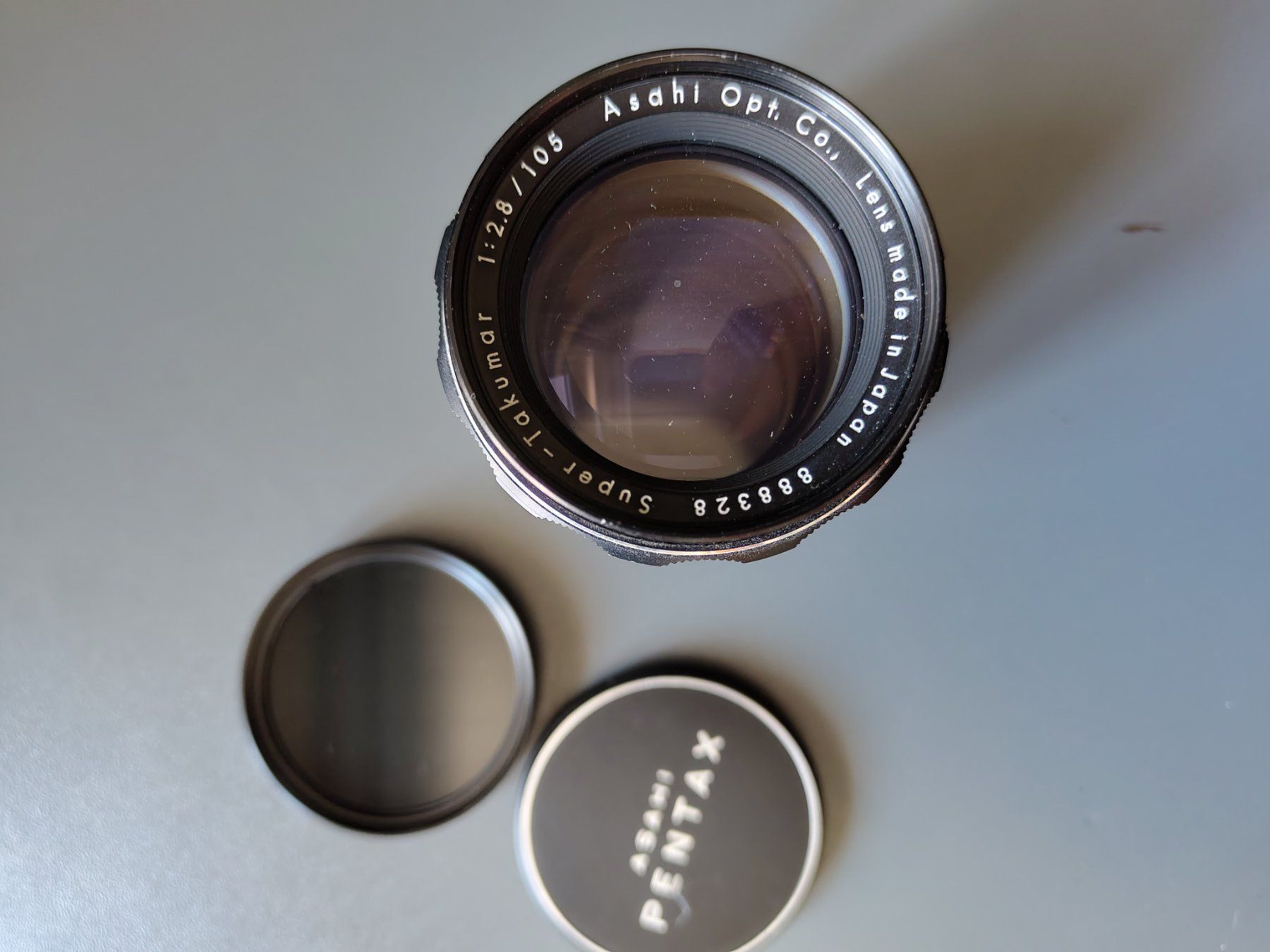 Pentax Obiettivi: Ashai Pentax Super Takumar 1:2.8/105 Objektiv – Usato da Basel venduto da OleThiele