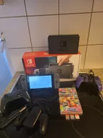 Nintendo Switch Konsole mit Zubehör und vier Spielen