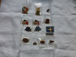 13 Pin's Sammlung: Jurassic Park, Flugzeug, SBB, USA!