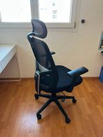 Chaise de bureau ergonomique noire avec appuie-tête
