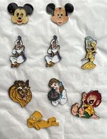 9 Ansteckpins mit 7 div. Comics-Figuren