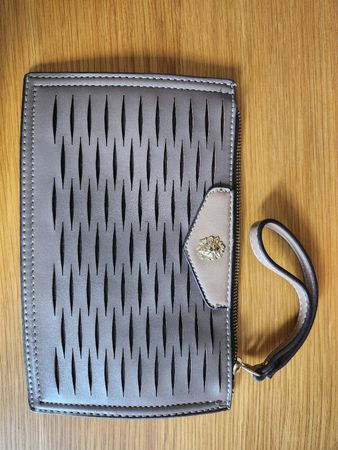 Clutch bag with perforated design and lion head detail 