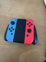 Nintendo Switch Joy-Con Neon-Rot/Blau + Halterung – ab 1.-