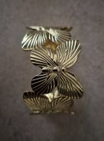 Bracelet manchette métal doré papillons