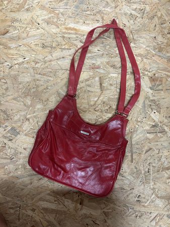 Red faux leather shoulder bag with adjustable strap
