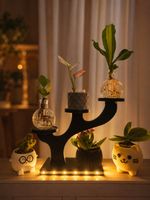 Supporto porta piante ad albero nero con vaso decorativo