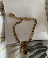 Bracciale Guess dorato con charm "G" e triangolino logo