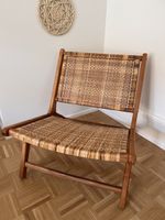 Lounge chair wood with woven seat in good condition. Rattan