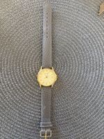 Montre Rotary plaqué or avec date bracelet cuir gris