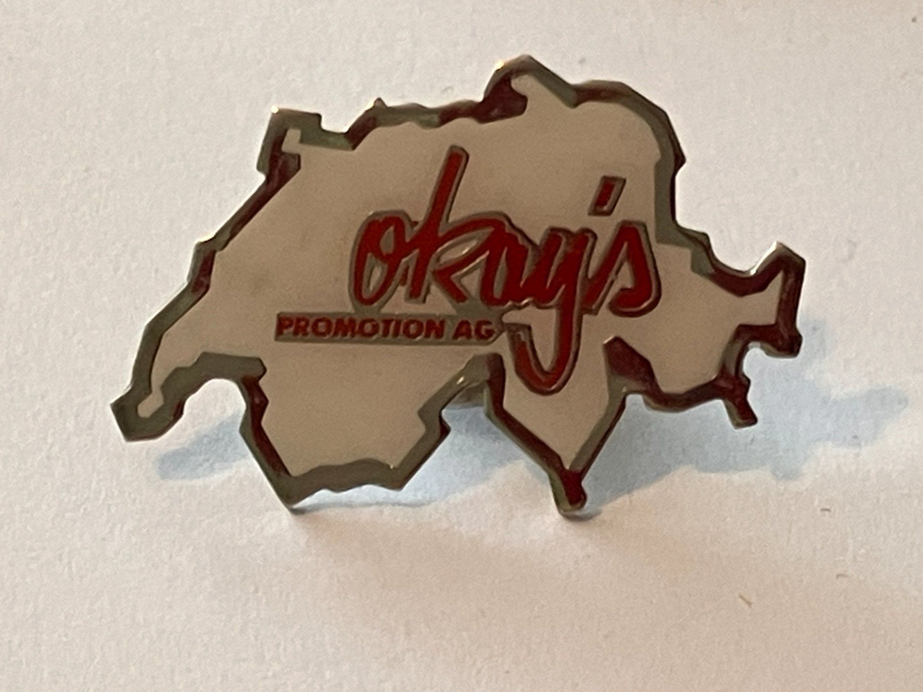 Plaketten & Abzeichen: 1 Pin Okay's Promotion AG – Gebraucht aus Basel von djwwpp