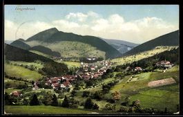 AK Langenbruck, Ortsansicht im Tal mit Kirche und Hügeln