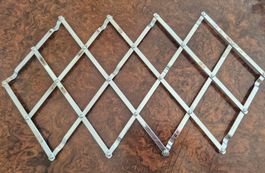 Ausziehbarer Topfuntersetzer aus Metall gebraucht