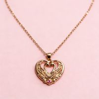 Collier doré, pendentif cygnes en coeur