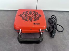 Melior Brezeleisen mit Schweizer Motiven rot