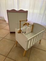 Puppenbett mit Mobile und Holzschrank