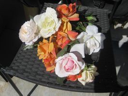 Schöne künstliche Rosen zum Teil mit Tautropfen
