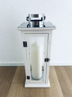 Large decorative wooden lantern with candle