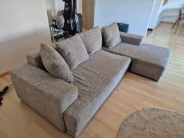 Ecksofa mit grauem Stoffbezug gebrauchter Zustand