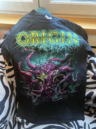 T-shirt Origin noir vintage, motif Evolution of Extinction.