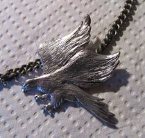 Silberfarbene Kette mit Adler Anhänger.