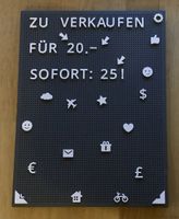 Graues Letterboard mit Buchstaben, Zahlen und Symbolen