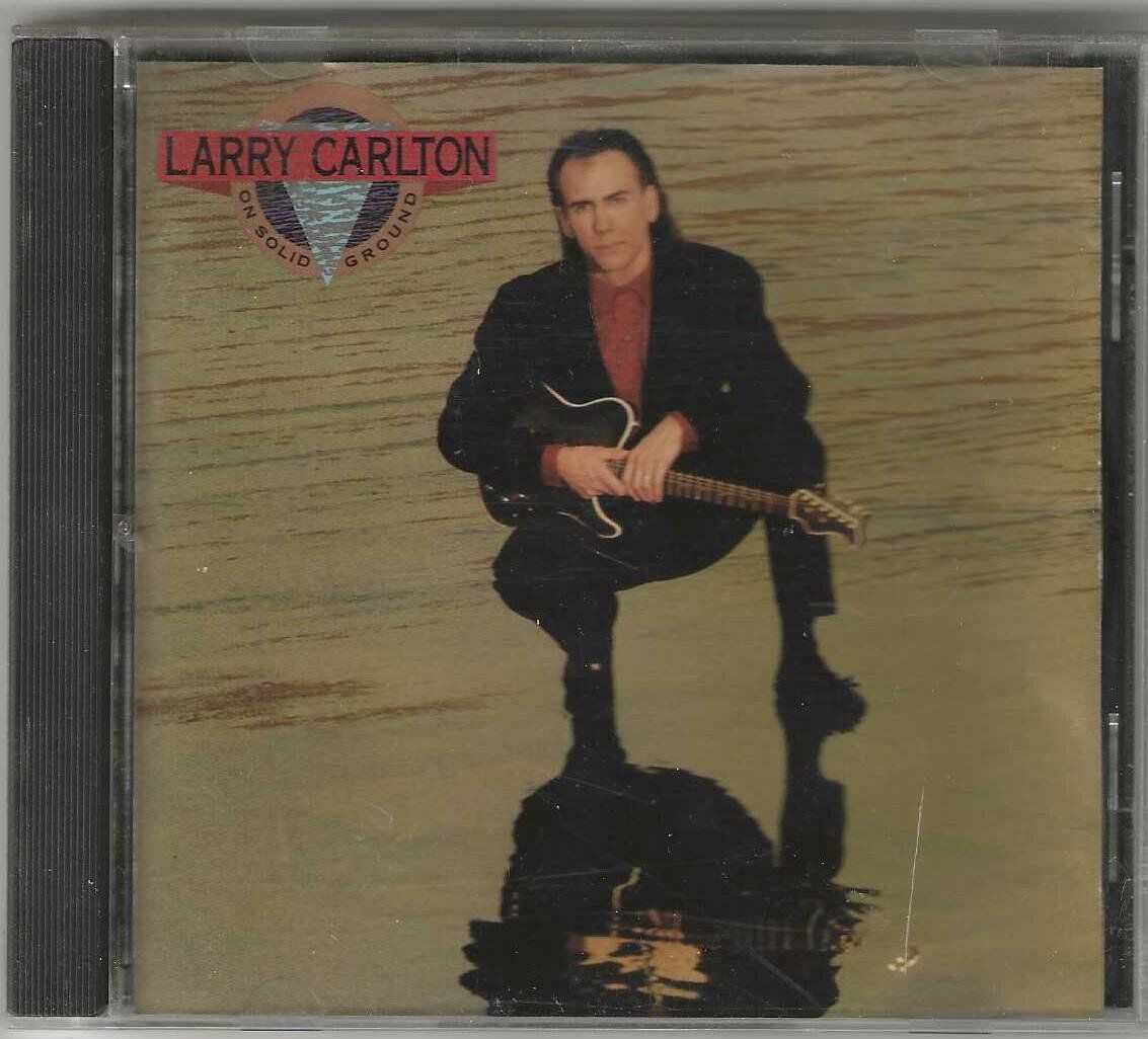 CD: Larry Carlton – On Solid Ground – Usato da Genève venduto da CDLPBookS