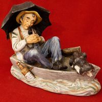 Figur Mann im Boot mit Hund