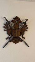 Wandschmuck mit geschnitztem Wappen u. gekreuzten Schwertern