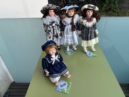 Lot de 4 poupées en porcelaine